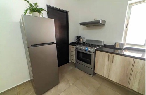 Alfredo V. Bonfil Apartment | Airport condo w/KING BED pool, security, kids game park + bbq area with lounge!
