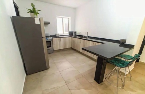 Alfredo V. Bonfil Apartment | Airport condo w/KING BED pool, security, kids game park + bbq area with lounge!