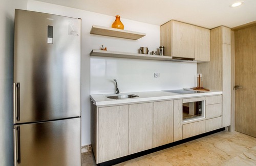 Zama Apartment | Beautiful apartment with rooftop pool, fitness area, & balcony