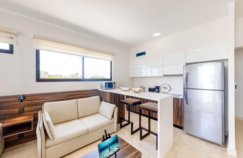 Zama Apartment | Fourth-floor studio with rooftop pool, partial A/C, city views, & balcony
