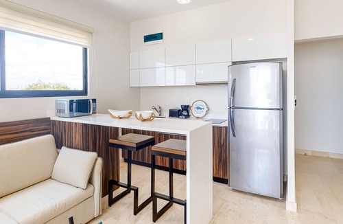 Zama Apartment | Fourth-floor studio with rooftop pool, partial A/C, city views, & balcony