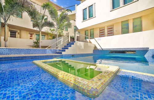 Gonzalo Guerrero Condo | Large, modern condo with balcony overlooking 5th Ave. 4 minute walk to the beach