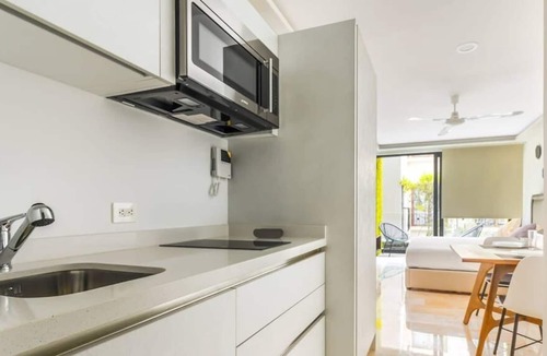 12th Street Apartment | Studio with AC Kitchen Pool Gym and Rooftop view