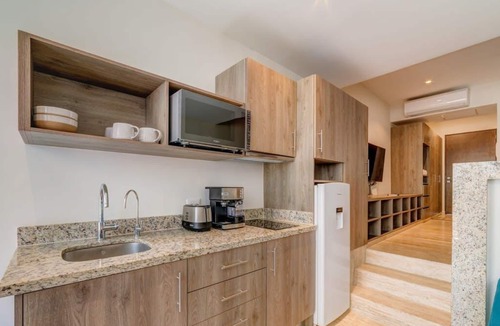 Centro Apartment | Stylish Playa Condo: Rooftop Pool, Gym, Near Beach